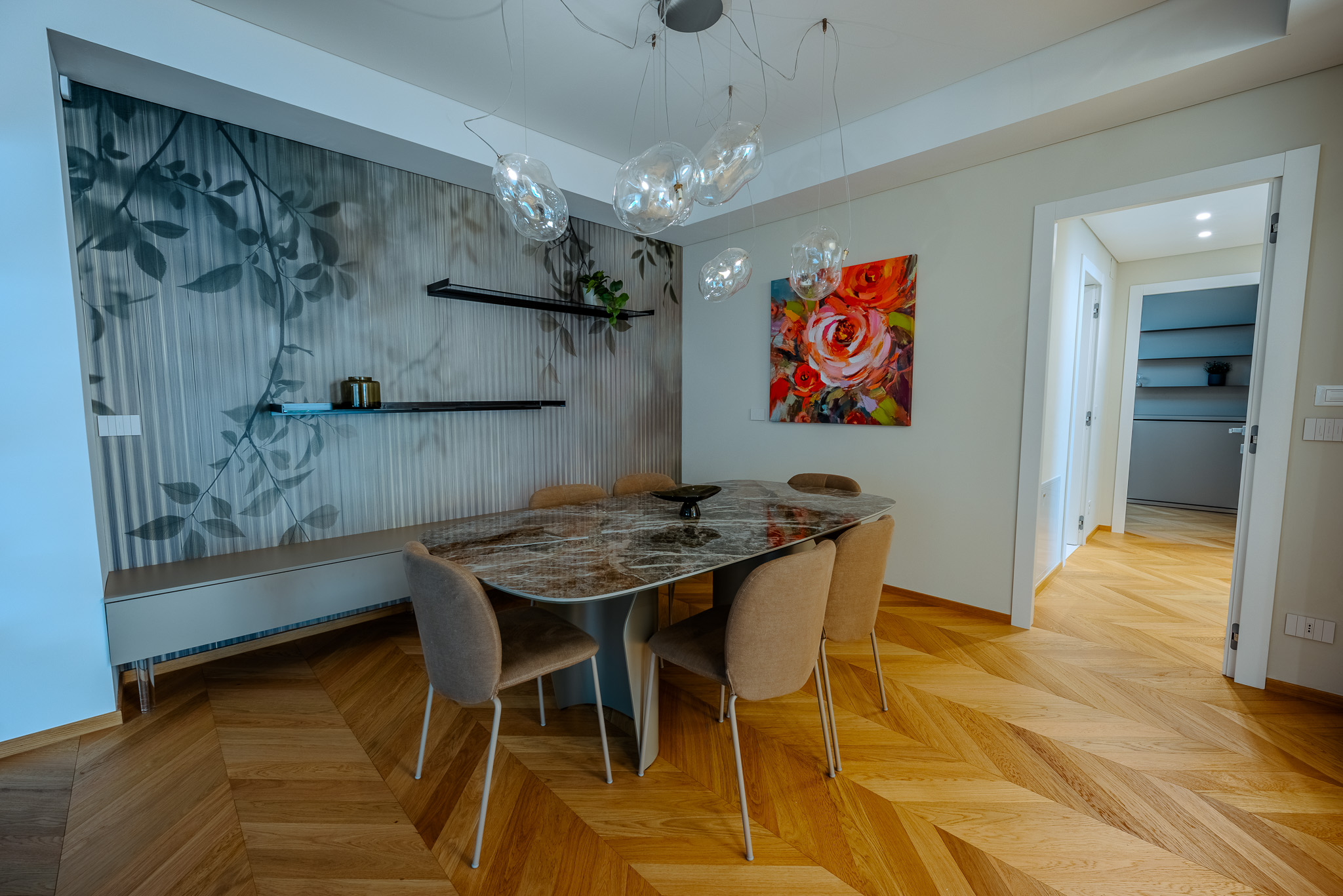 Sala da pranzo con quadro a rose e vista cucina