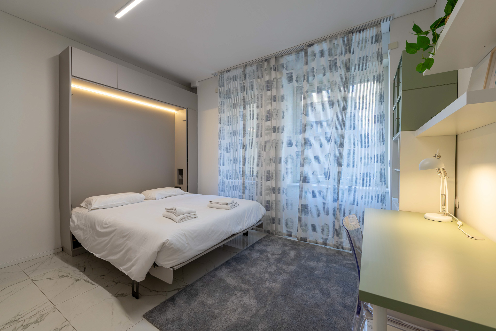 Second bedroom with LED wardrobe, desk and patterned curtain
