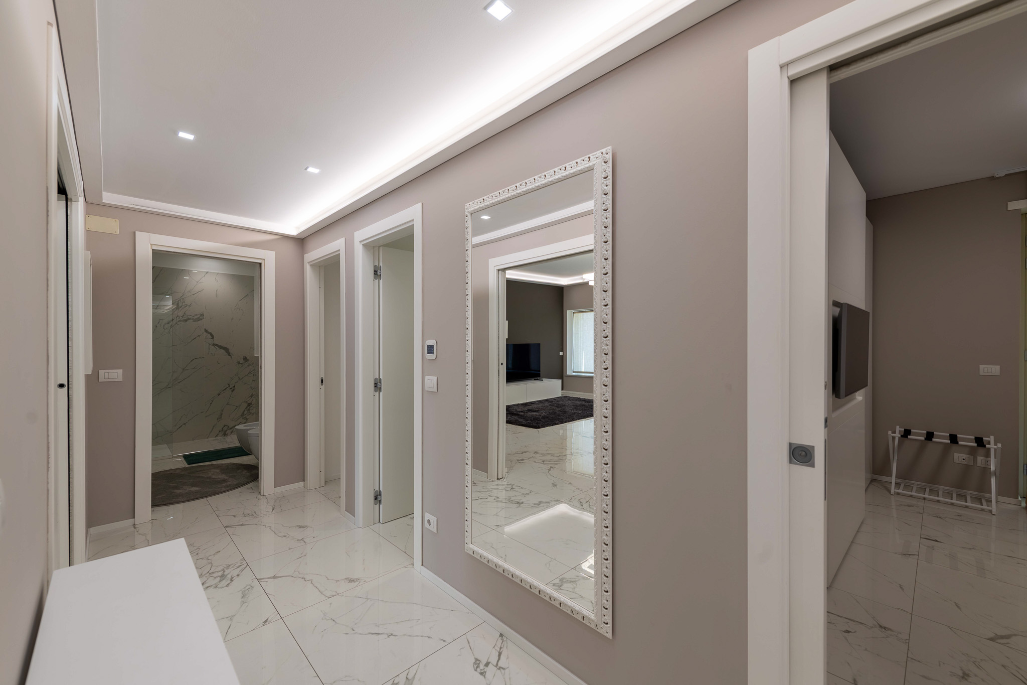 Night hallway with mirrors and marble floor