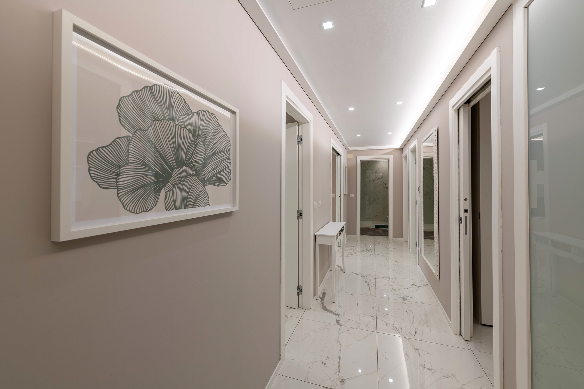 Marble hallway with botanical print and mirrored doors