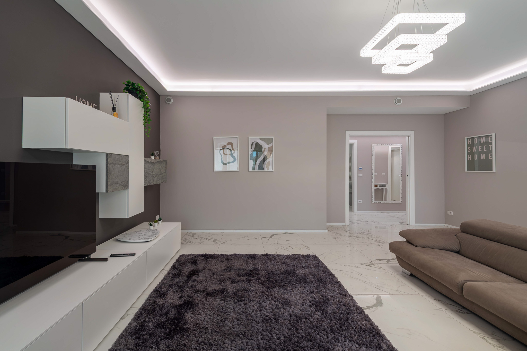 Living with modular sofa and charcoal TV wall