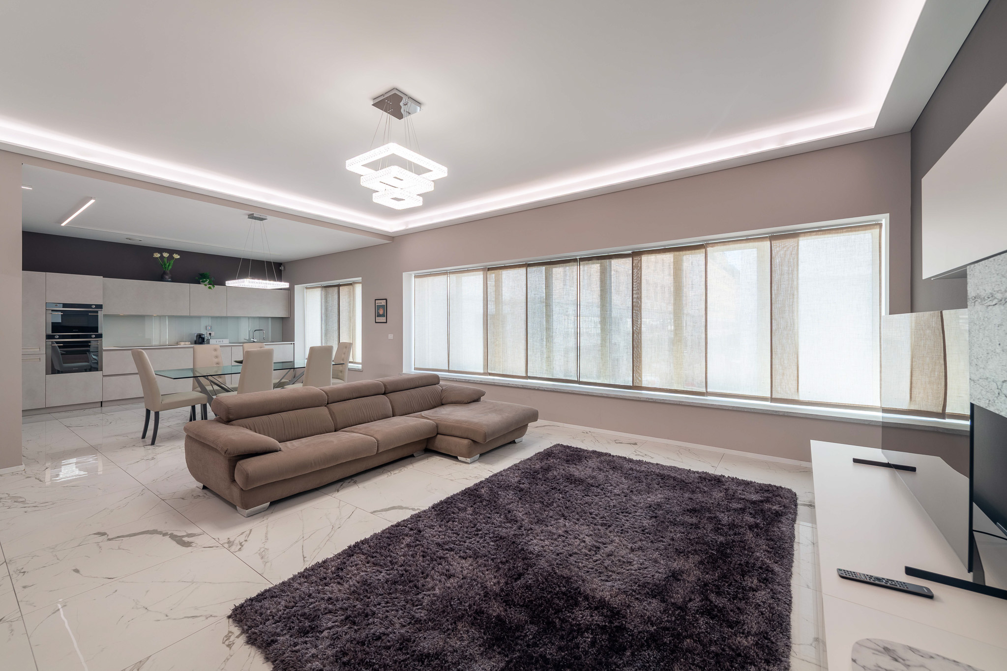 Bright living room with large window and rug