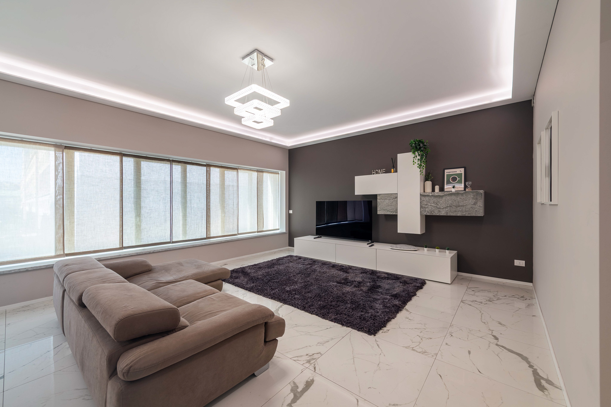 Living room with modular sofa and white TV unit