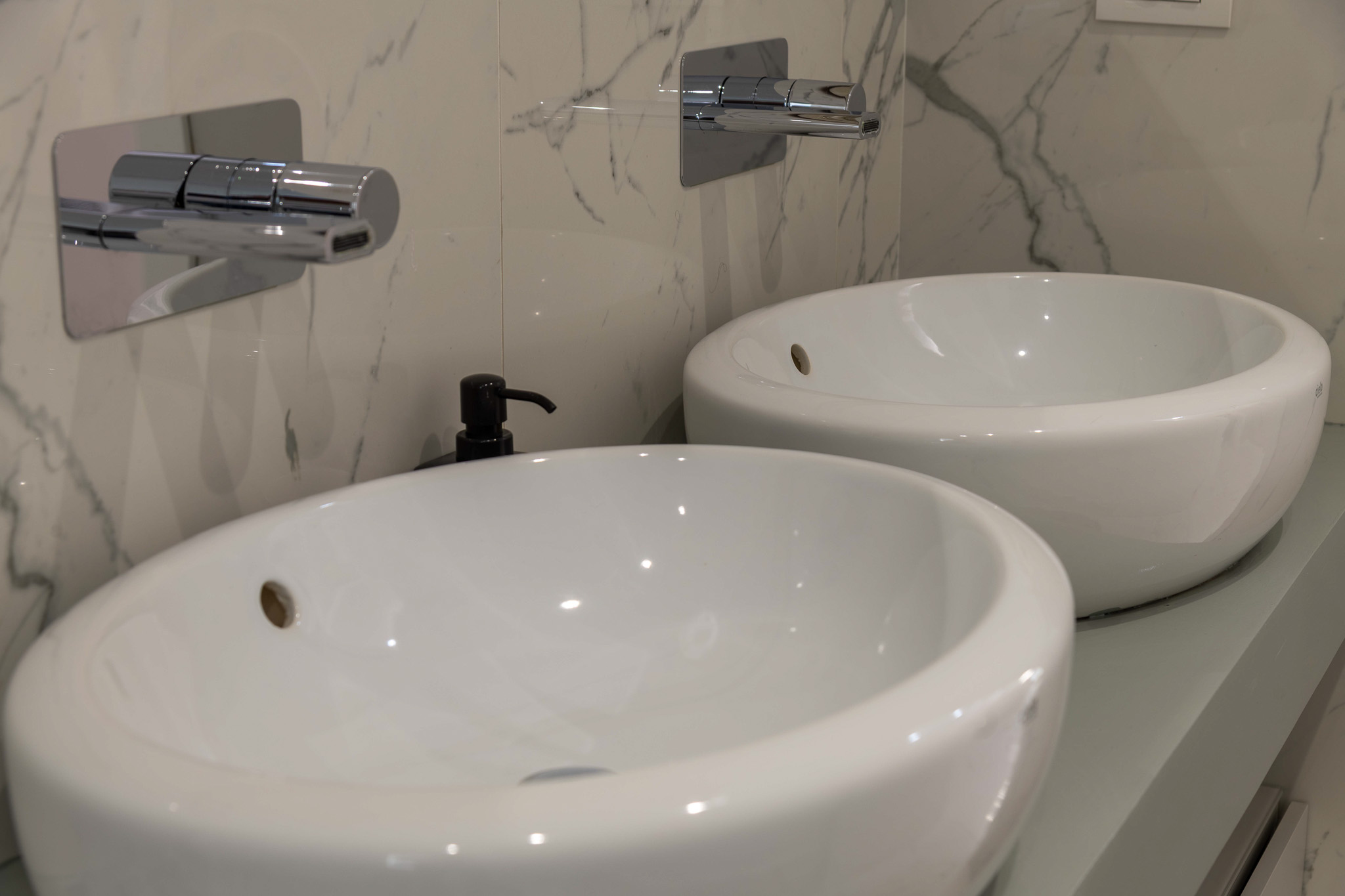 Bathroom detail: double ceramic vessel sinks