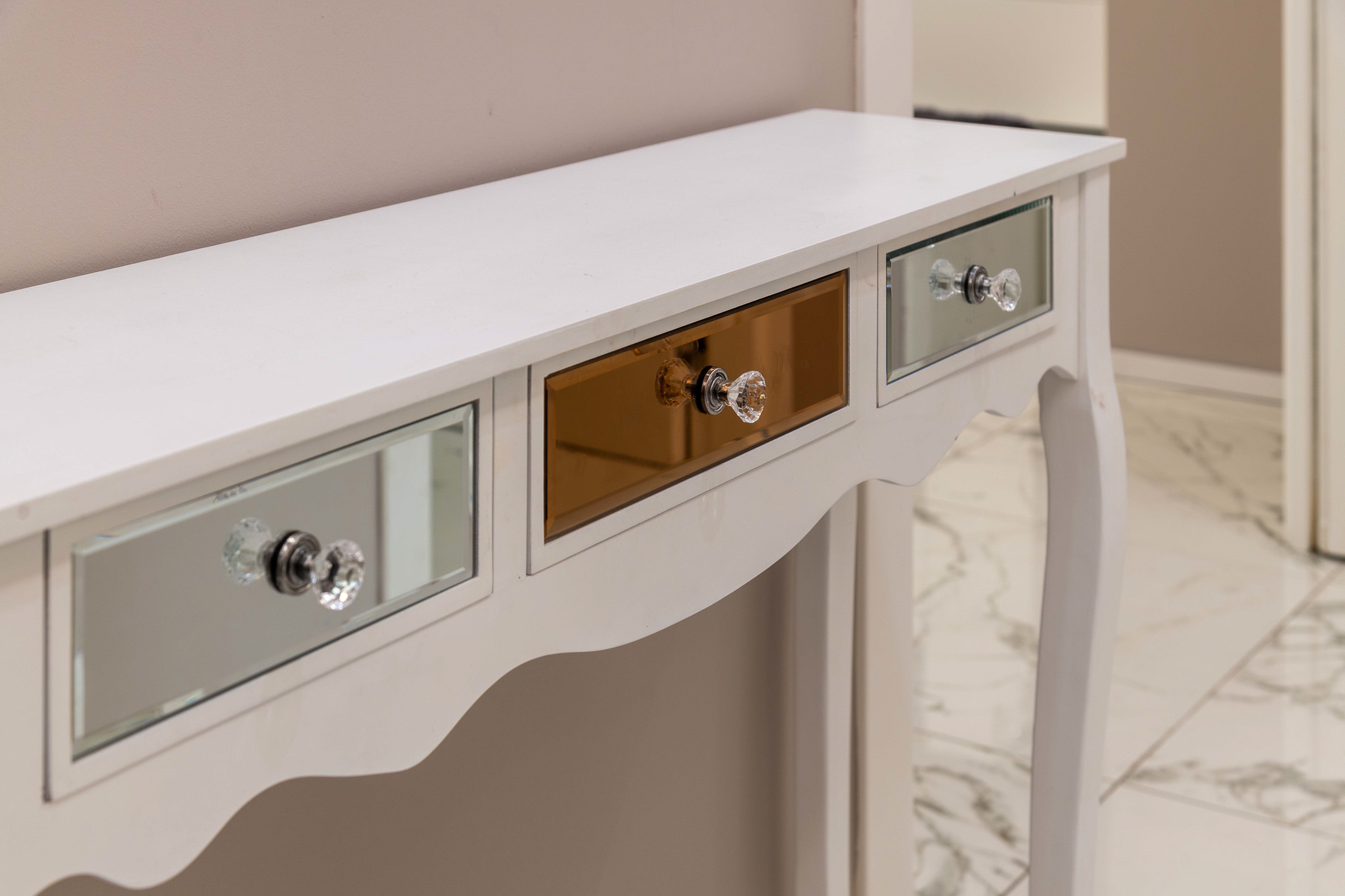 Detail: white console with mirrored drawers